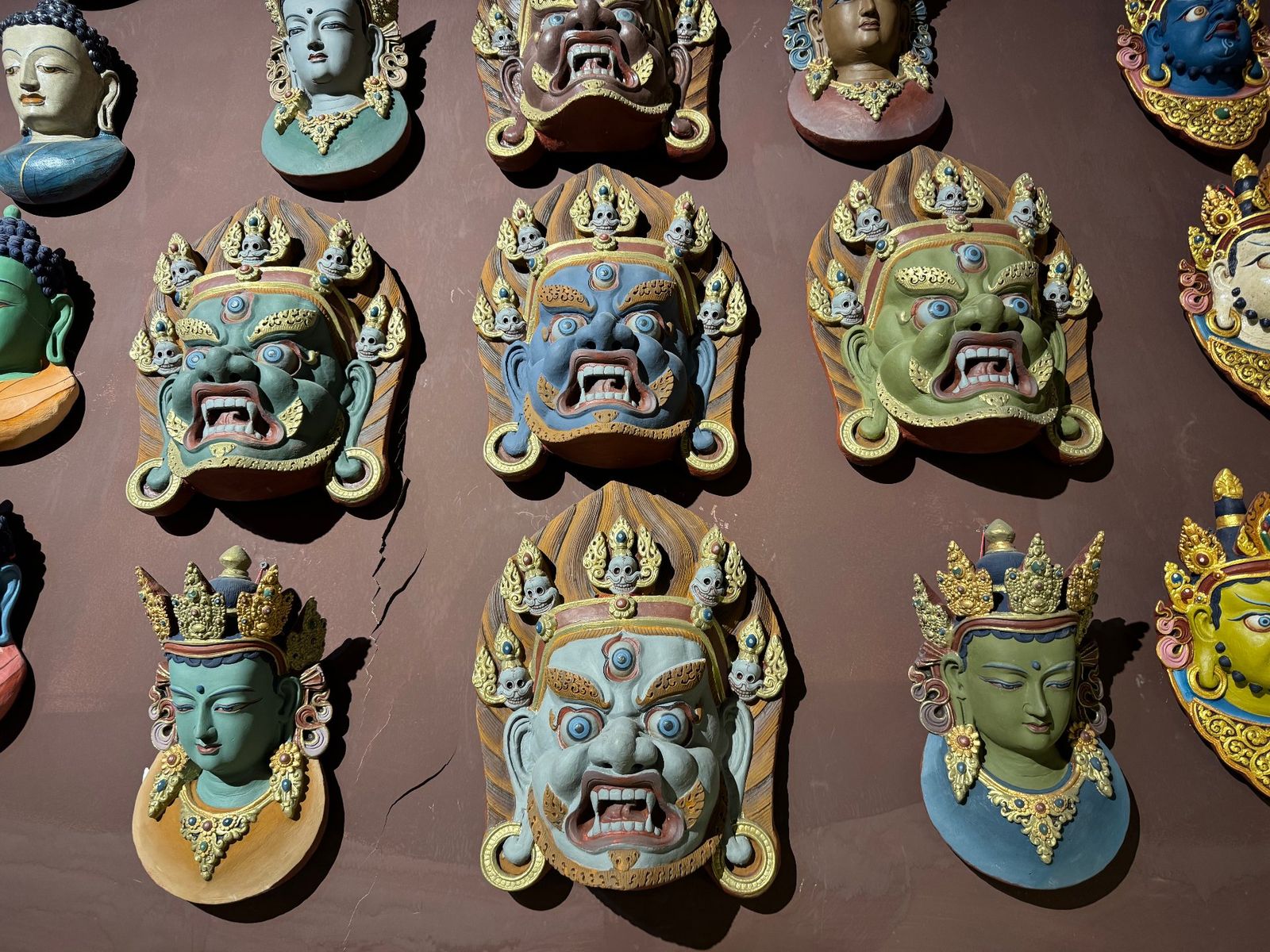 Wall of Tibetan medicine-clay masks in a Lhasa studio